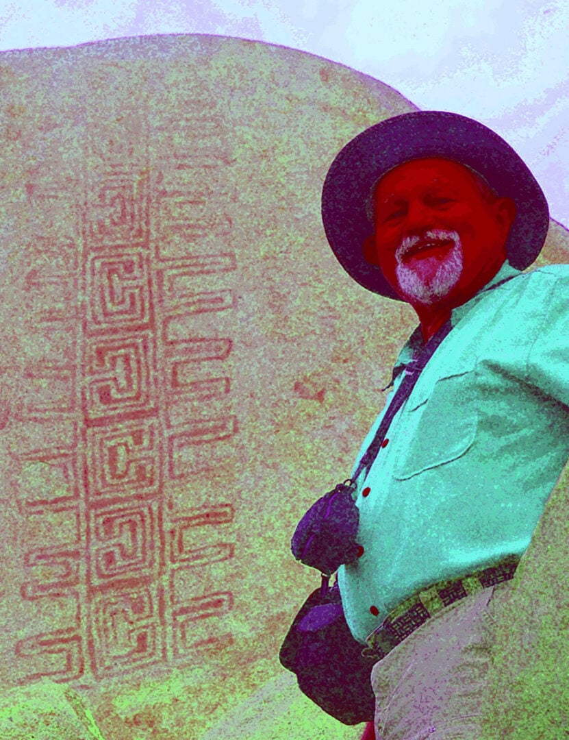 Jon Harman poses in front of an example of the Rancho Bernardo style of Native American artwork that’s barely visible until Dstretch is applied. Credit: Jon Harman (via NASA)
