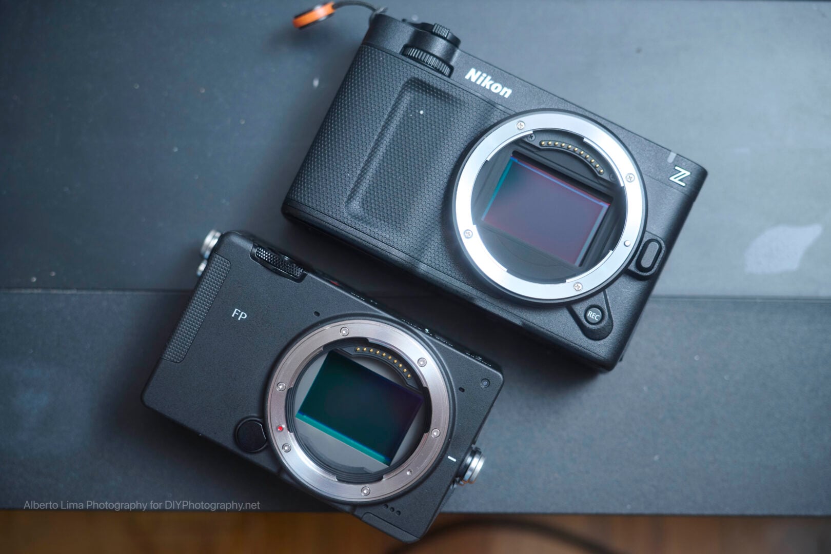 The Sigma FP2 with an exposed sensor lined up underneath the Nikon ZR to illustrate the size difference.